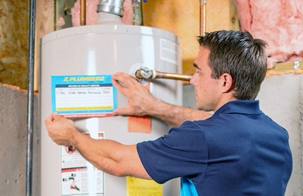 Z PLUMBERS tech servicing a hot water heater