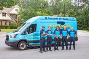 ZPLUMBERS technicians standing in front of work van