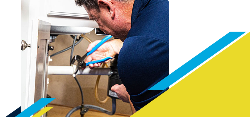 Z PLUMBERZ technician fixing pipe under a sink