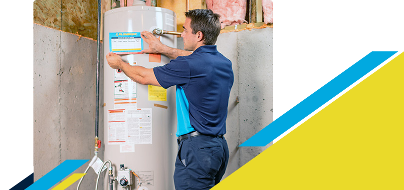 Z PLUMBERZ technician placing label on a water heater