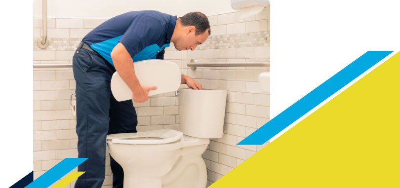 Z PLUMBERZ technician inspecting top chamber of a toilet